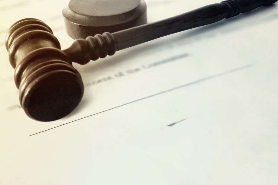 A gavel on a white paper with writings on it. Clicking it will take you to the legislation and subsidiary legislation related to the Property Market Agency.